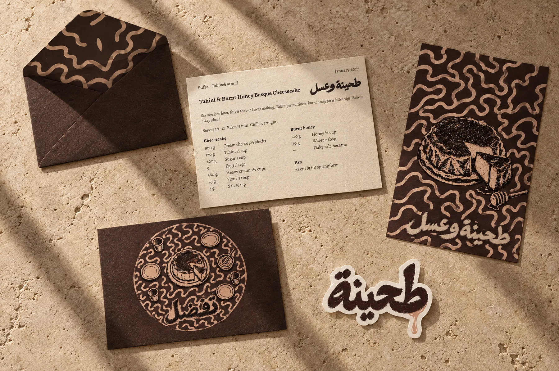 Everything from one envelope on a travertine table in late sun: the envelope, the recipe card, the postcard, the invitation and the tahini sticker